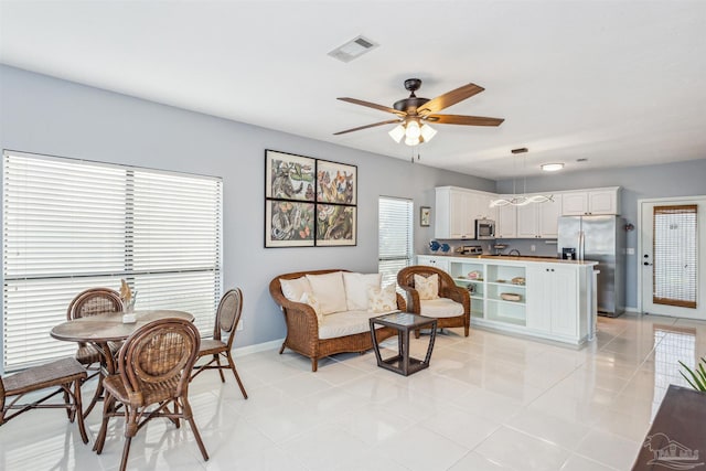 interior space with ceiling fan