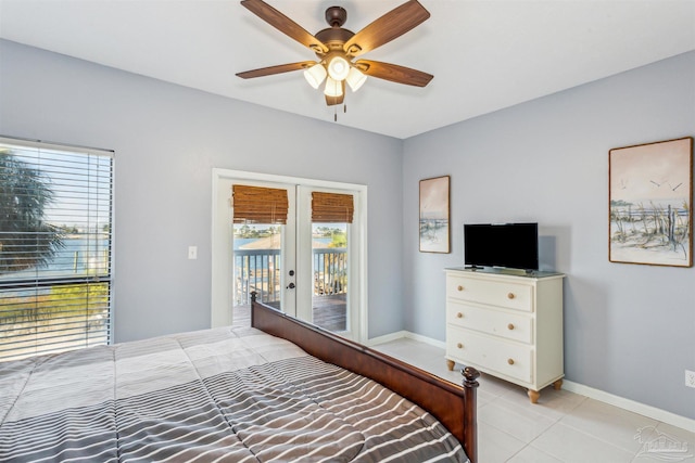 tiled bedroom with access to exterior, ceiling fan, and french doors