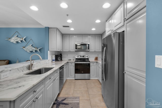 kitchen featuring gray cabinets, sink, stainless steel appliances, and tasteful backsplash