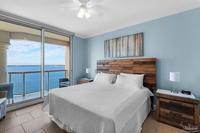 bedroom with access to exterior, ceiling fan, a water view, and multiple windows