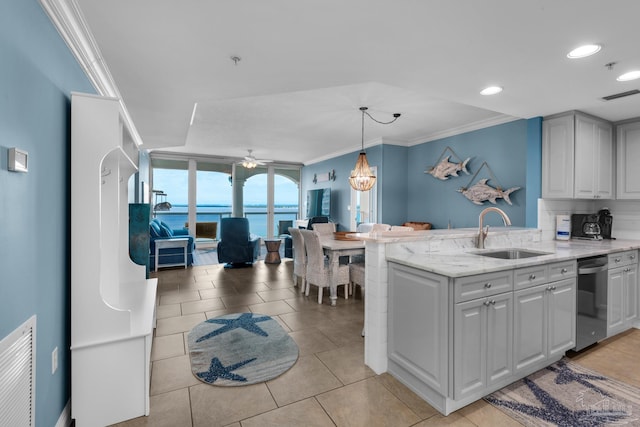 kitchen featuring ceiling fan, sink, a water view, dishwasher, and hanging light fixtures