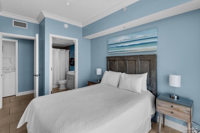 tiled bedroom featuring washer / dryer, ornamental molding, and connected bathroom