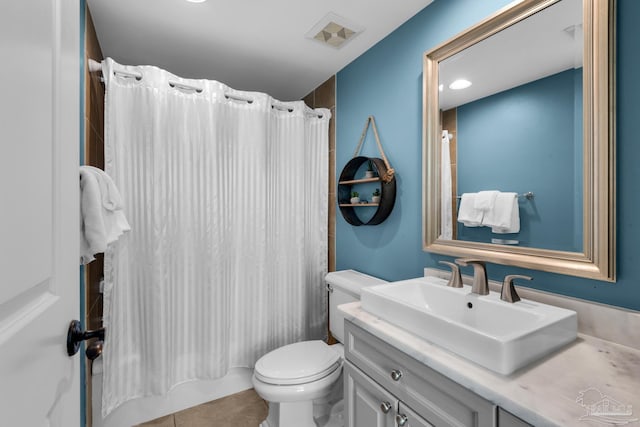 full bathroom with tile patterned flooring, shower / tub combo, vanity, and toilet