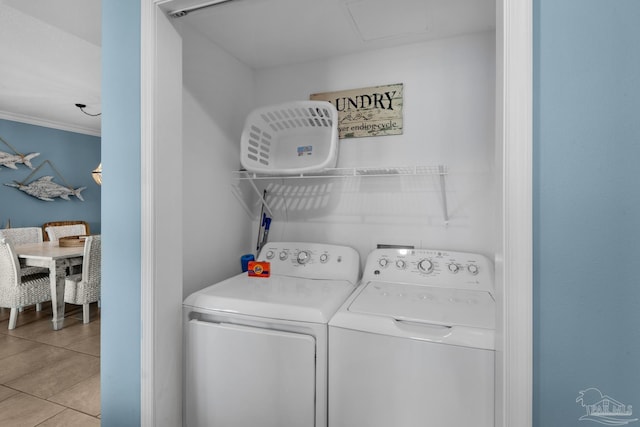 laundry area with light tile patterned floors, separate washer and dryer, and ornamental molding