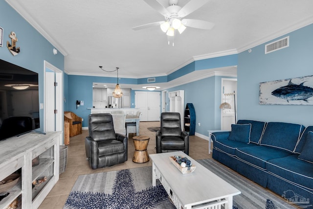 living room featuring crown molding, light tile patterned flooring, and ceiling fan