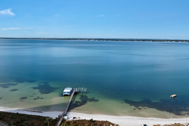 property view of water with a dock and a view of the beach