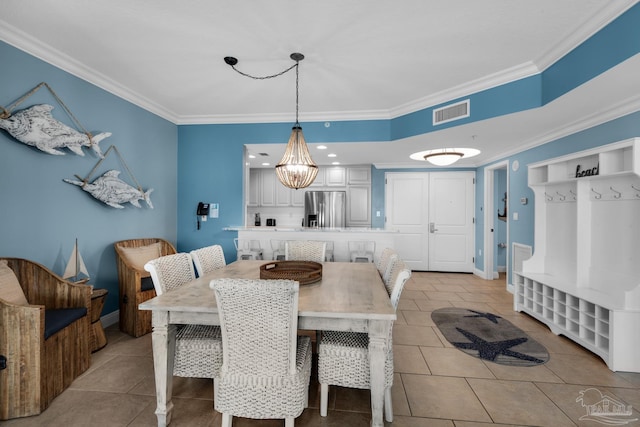 dining room featuring light tile patterned flooring and ornamental molding