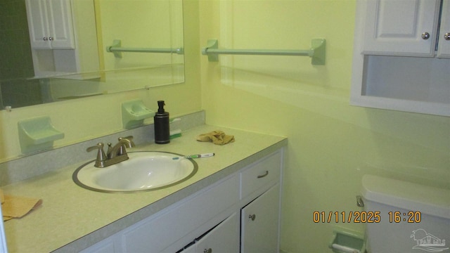 bathroom with toilet and vanity