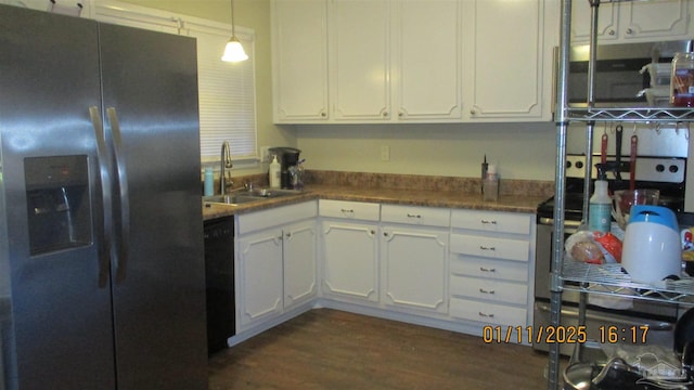 kitchen with sink, hanging light fixtures, white cabinetry, and stainless steel refrigerator with ice dispenser