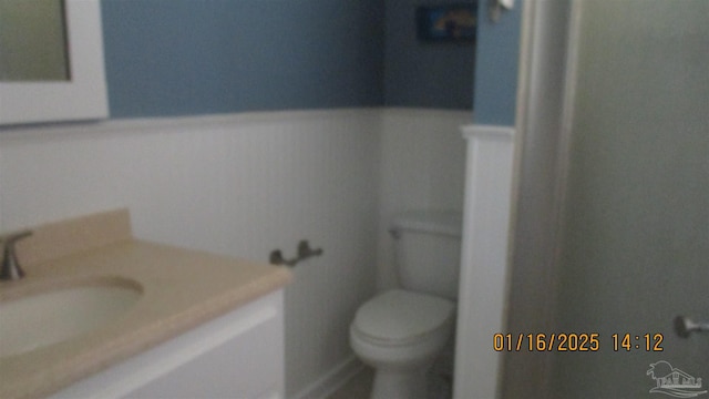 bathroom featuring vanity and toilet