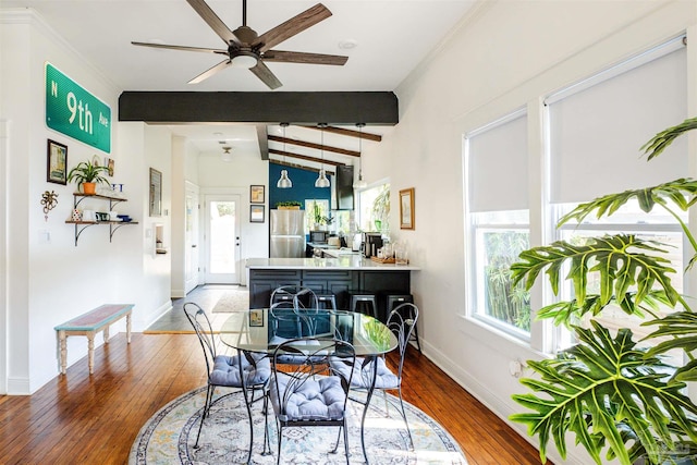 dining room featuring ceiling fan, lofted ceiling with beams, and dark hardwood / wood-style floors