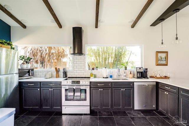 kitchen with beamed ceiling, stainless steel appliances, extractor fan, and hanging light fixtures