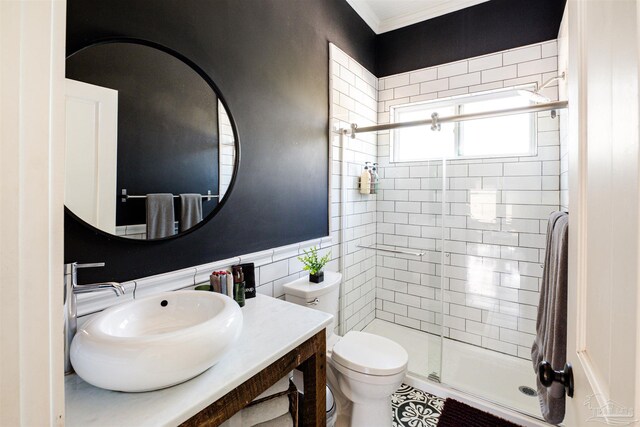 bathroom featuring walk in shower, sink, ornamental molding, and toilet