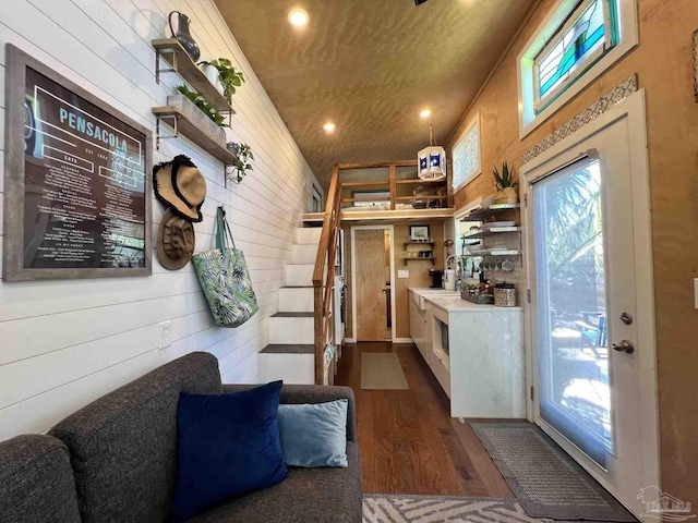 interior space featuring wood walls and dark wood-type flooring