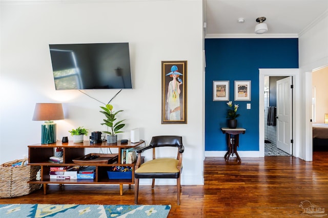 living area with dark hardwood / wood-style floors and crown molding