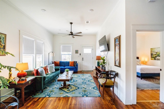 living room with ceiling fan, dark hardwood / wood-style floors, and ornamental molding