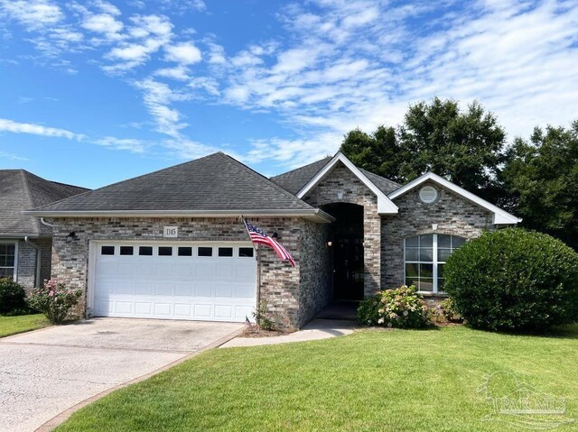 view of front of house featuring a front yard and a garage