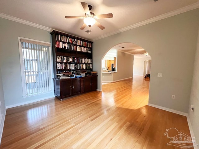 interior space with ceiling fan, light hardwood / wood-style floors, and crown molding