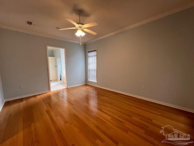 spare room with crown molding, light hardwood / wood-style flooring, and ceiling fan