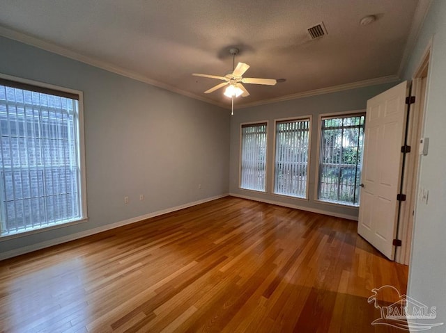 unfurnished bedroom featuring wood-type flooring, ornamental molding, and ceiling fan