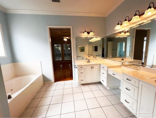 bathroom with crown molding, vanity, ceiling fan, and a washtub