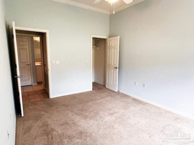 unfurnished bedroom featuring crown molding, ceiling fan, and light colored carpet