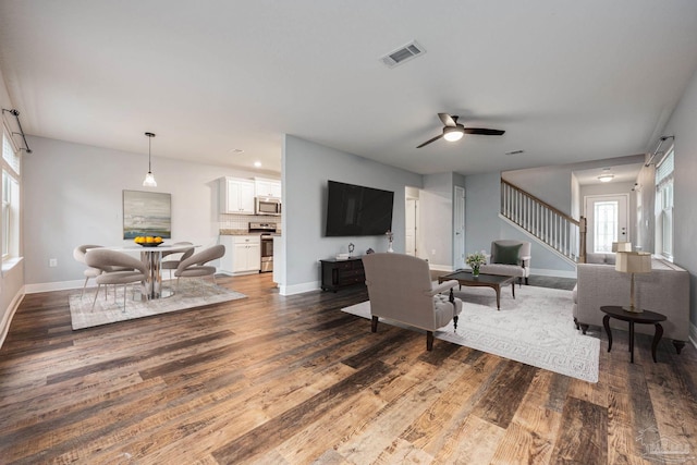 1885 Natures Way, Gulf Breeze, FL 32563 - living room with wood finished floors, stairs, baseboards, and ceiling fan