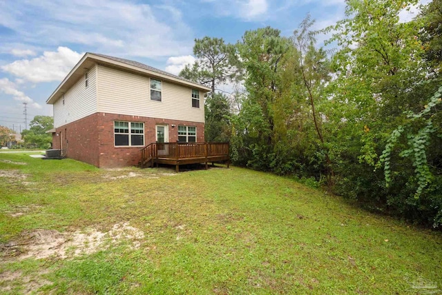 rear view of house featuring a yard, central AC, and a wooden deck