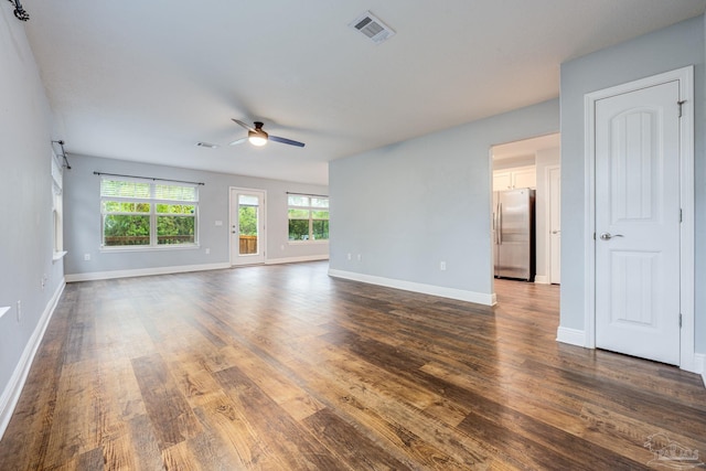 unfurnished living room featuring ceiling fan and dark hardwood / wood-style floors