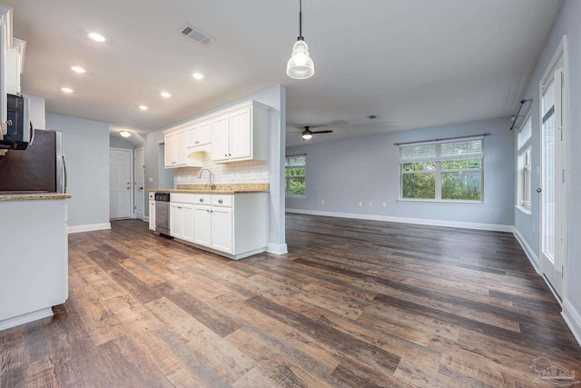 1885 Natures Way, Gulf Breeze, FL 32563 - kitchen with freestanding refrigerator, a ceiling fan, open floor plan, a sink, and white cabinets