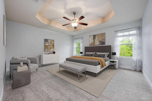 1885 Natures Way, Gulf Breeze, FL 32563 - carpeted bedroom with a tray ceiling, baseboards, and ceiling fan