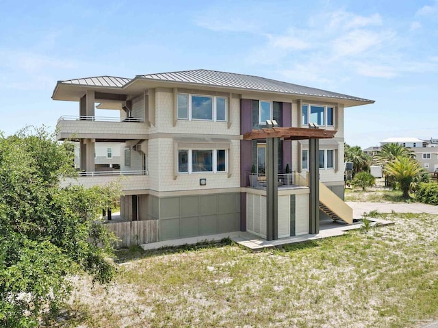 rear view of property featuring a balcony, a pergola, and a yard