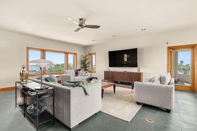 living area with recessed lighting, baseboards, and ceiling fan