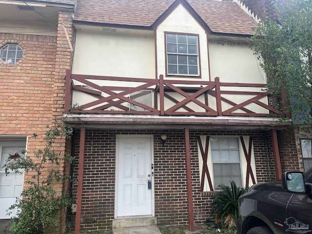 entrance to property with a balcony