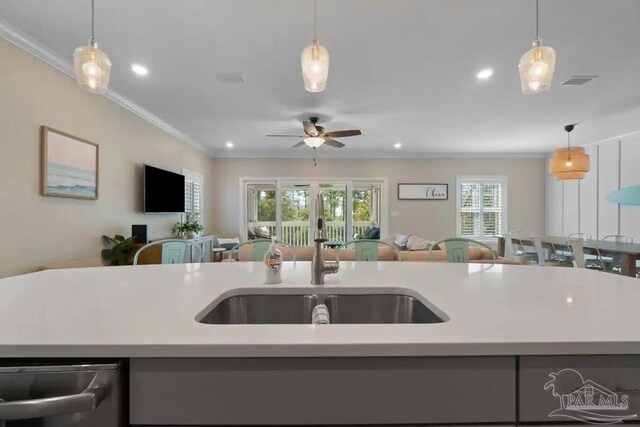 6635 Carlinga Dr, Pensacola, FL 32507 - kitchen with open floor plan, a sink, crown molding, light countertops, and recessed lighting