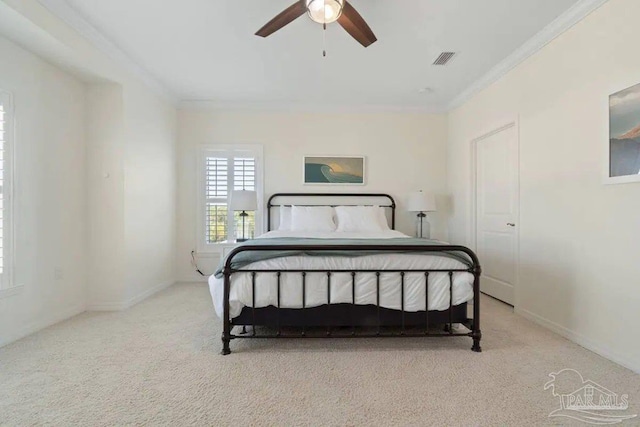 bedroom with crown molding, light carpet, and ceiling fan