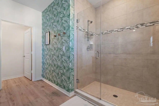 6635 Carlinga Dr, Pensacola, FL 32507 - bathroom with a shower stall, baseboards, wood finished floors, and wallpapered walls