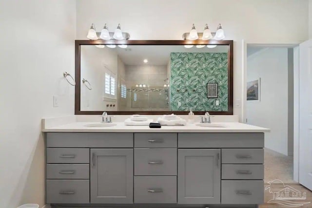 bathroom featuring walk in shower and vanity