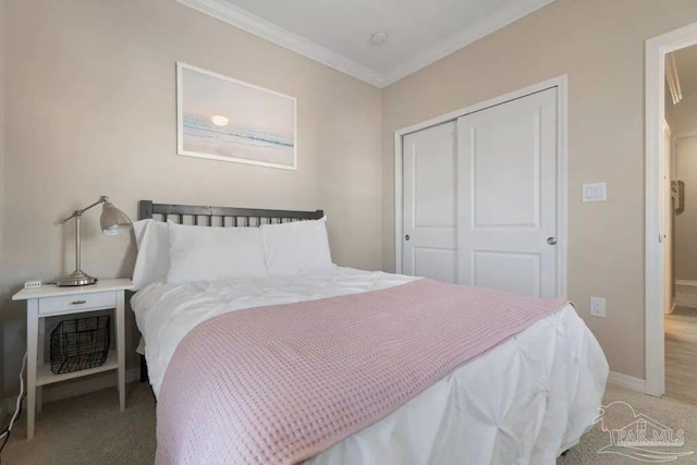 bedroom featuring ornamental molding, light carpet, and a closet