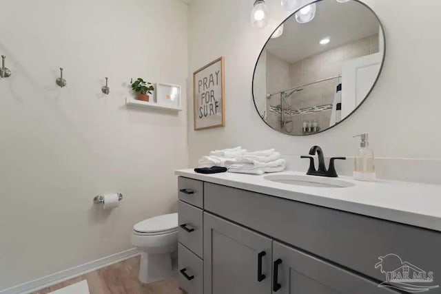 6635 Carlinga Dr, Pensacola, FL 32507 - bathroom with wood finished floors, toilet, vanity, a shower with curtain, and baseboards