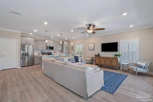 living room with ceiling fan, light hardwood / wood-style flooring, and ornamental molding