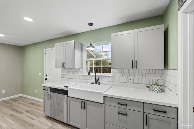 3985 Whitehall Dr, Pace, FL 32571 - kitchen with gray cabinetry, a sink, backsplash, and dishwasher