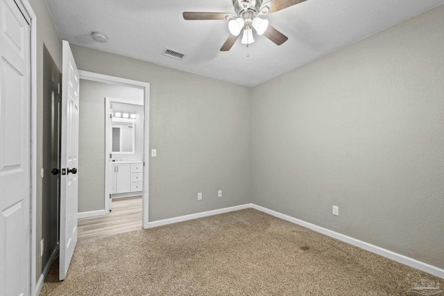 3985 Whitehall Dr, Pace, FL 32571 - unfurnished bedroom with light colored carpet, visible vents, baseboards, and a ceiling fan