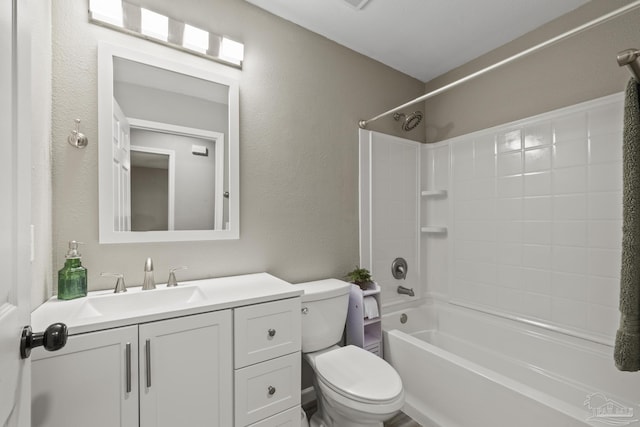 3985 Whitehall Dr, Pace, FL 32571 - bathroom with toilet, vanity, a textured wall, and bathtub / shower combination