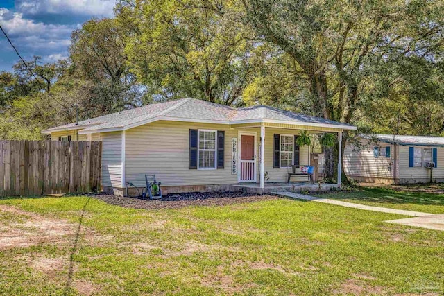 3985 Whitehall Dr, Pace, FL 32571 - view of front of home featuring a front lawn, covered porch, and fence