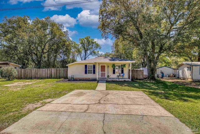 3985 Whitehall Dr, Pace, FL 32571 - bungalow-style house with covered porch, fence, and a front lawn