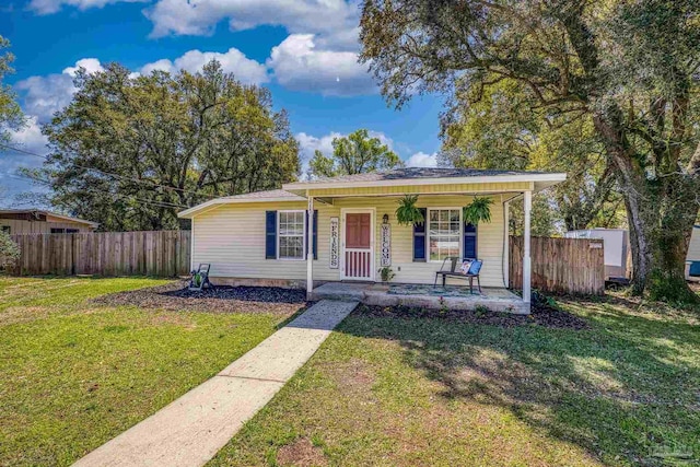 3985 Whitehall Dr, Pace, FL 32571 - bungalow-style home with a front lawn, covered porch, and fence