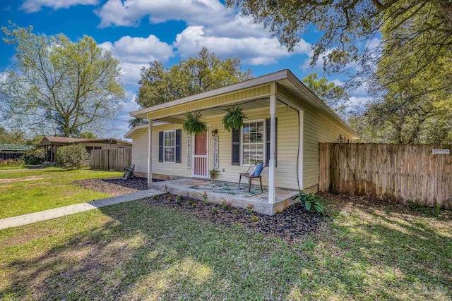 3985 Whitehall Dr, Pace, FL 32571 - bungalow-style home with covered porch, a front yard, and fence
