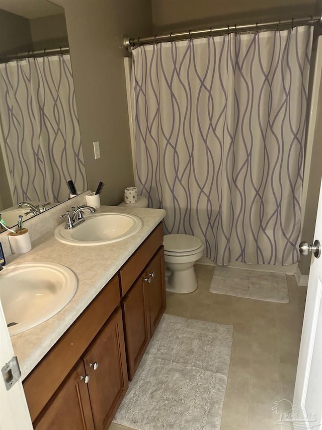 bathroom with vanity, tile patterned floors, and toilet