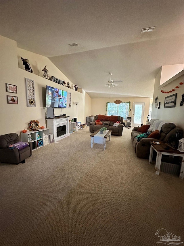 living room with lofted ceiling, carpet flooring, and ceiling fan